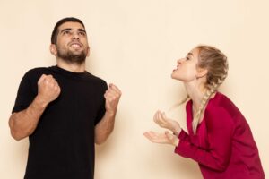 young female in red shirt quarelling with male